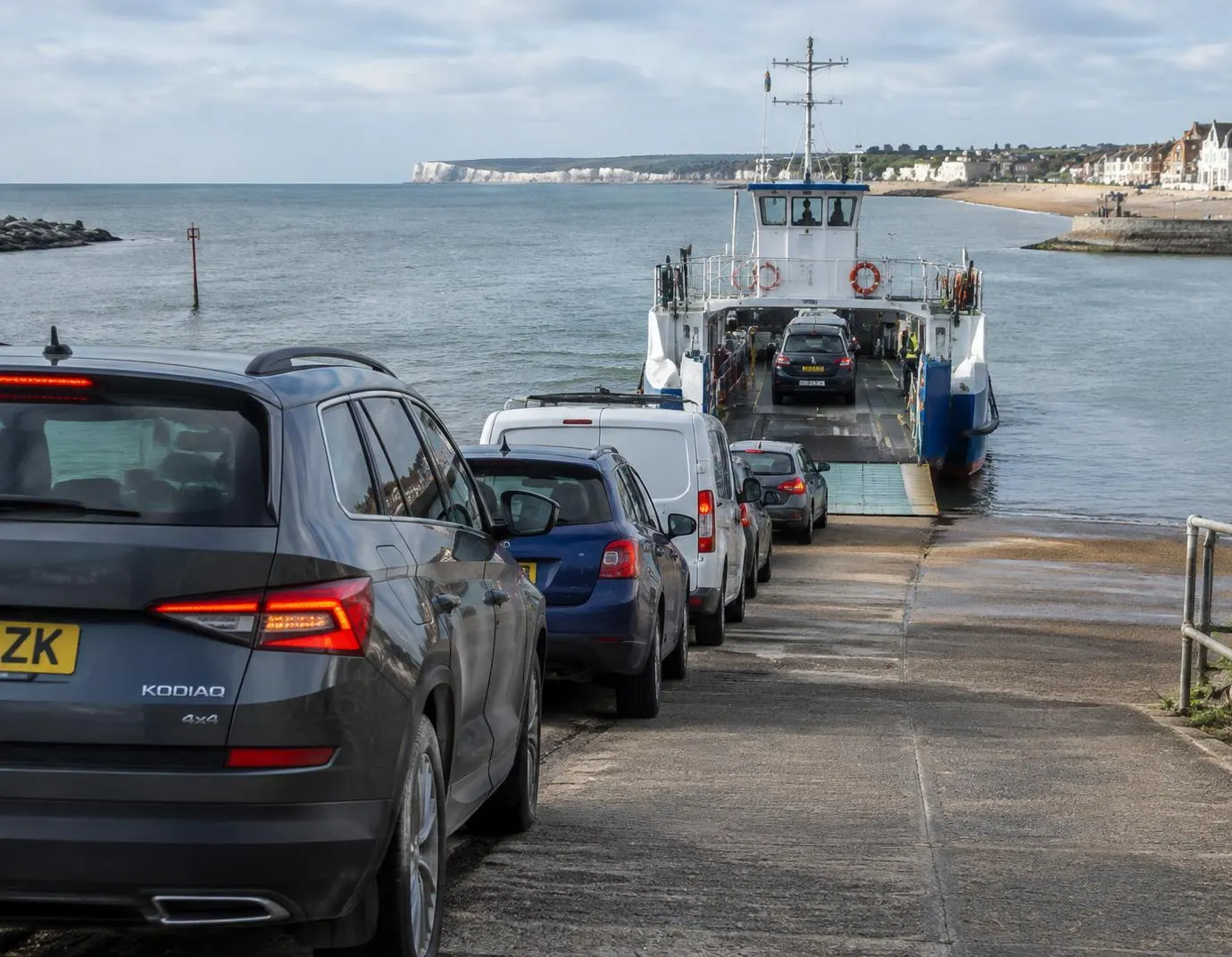 Cars queueing on a slipway to board a vehicle ferry — an illustration of a Sandbanks Ferry car crossing
